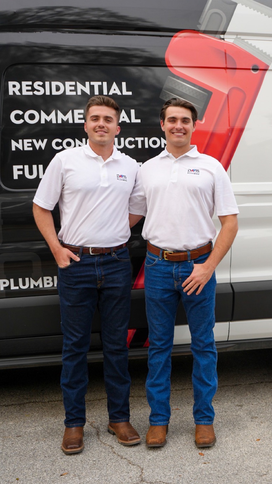 Zack and Zane Davis in front of their plumbing van